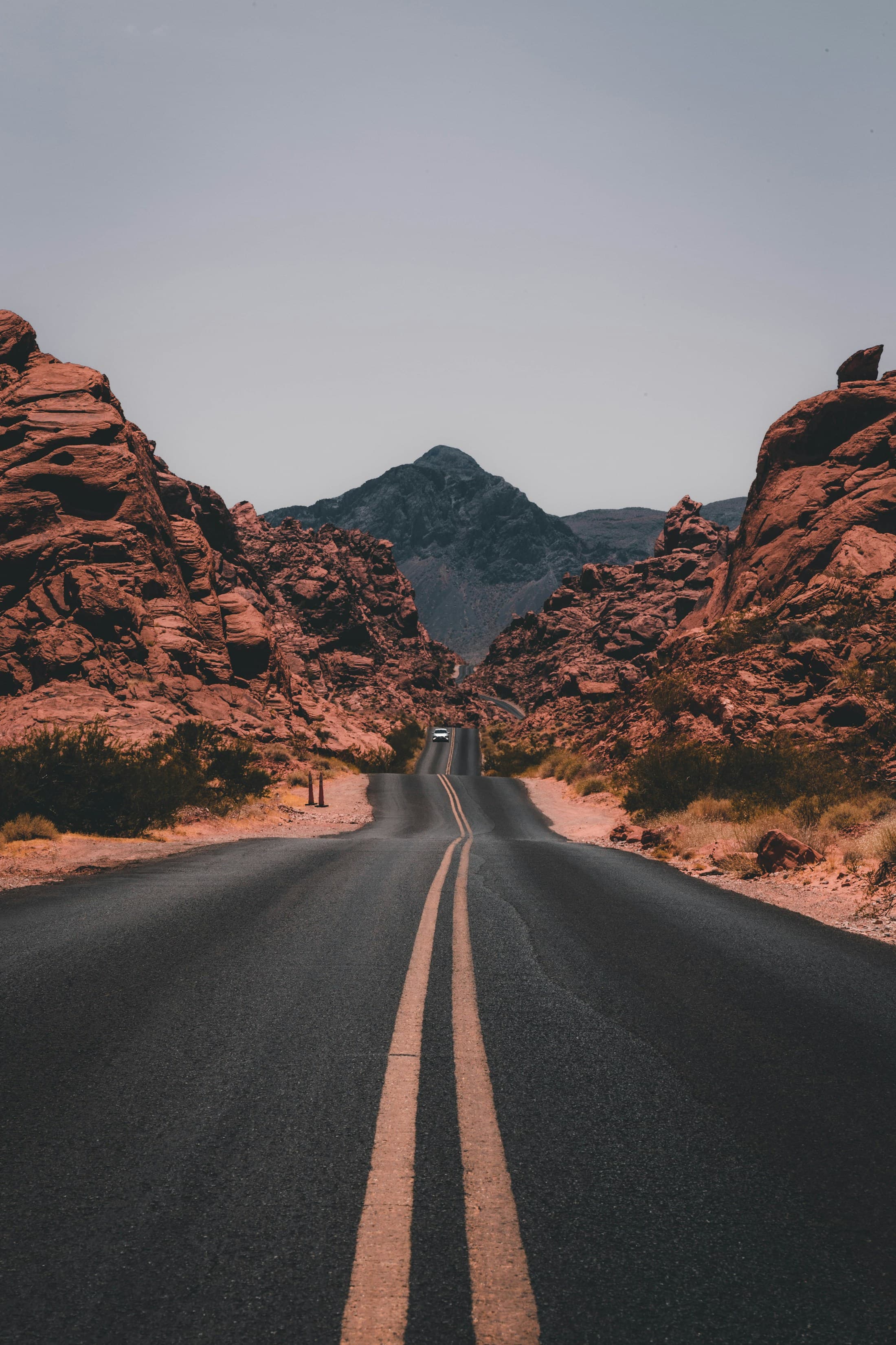 A remote road winding through a wide desert landscape